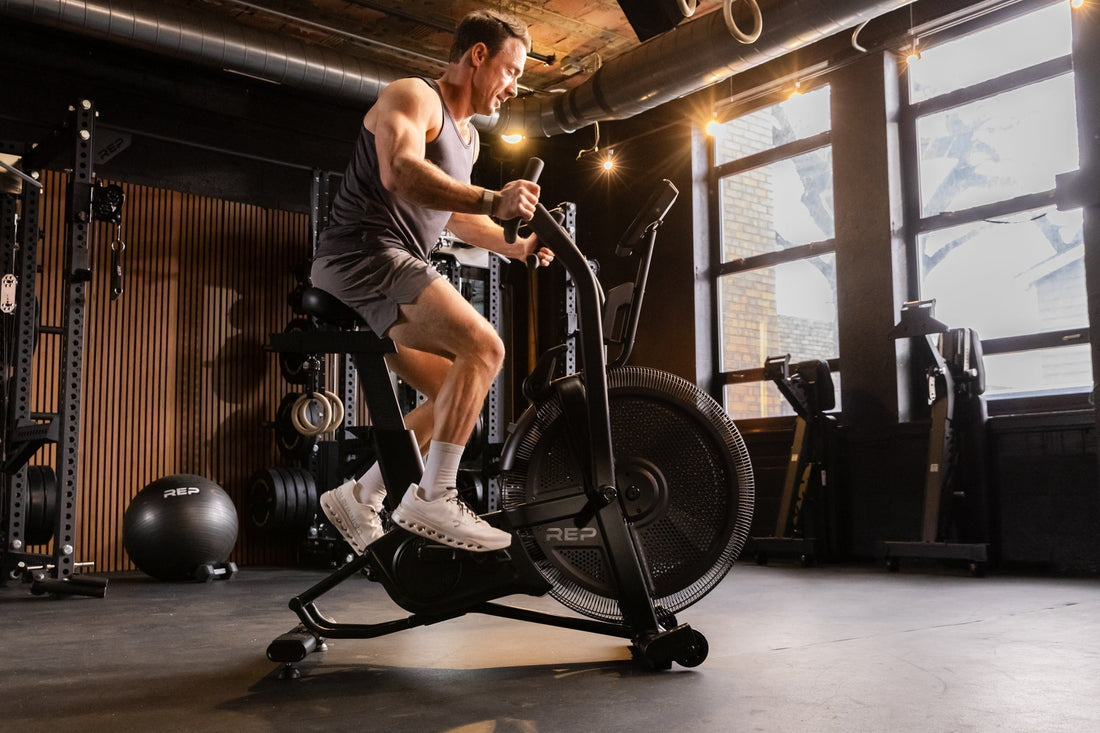 Athlete works on the Strive™ Air Bike featuring VPR™.