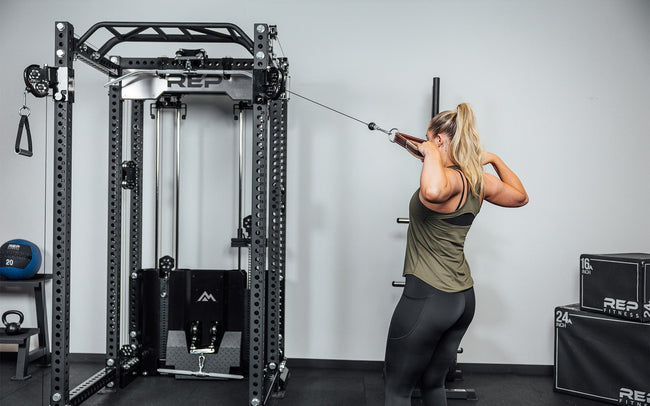 Woman doing face pulls using the Ares 2.0 and the REP USA Leather Accessory Strap