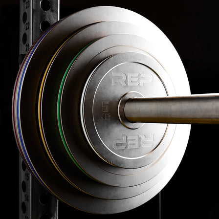 REP Fitness Calibrated Steel Plates in KG loaded onto a barbell on a PR-5000 rack